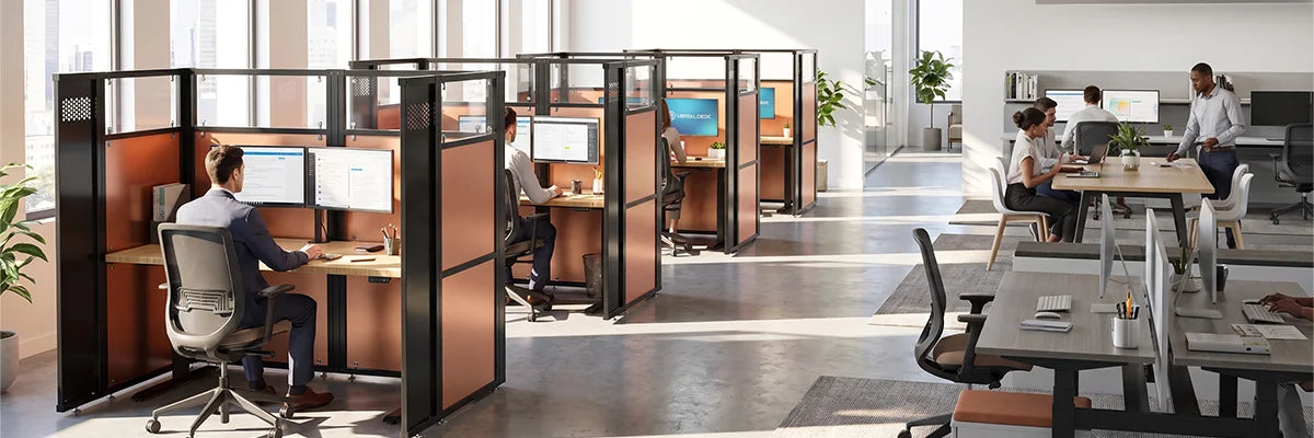 Modern hybrid office combining open workstations and WorkNest cubicles with height-adjustable desks in professional setting