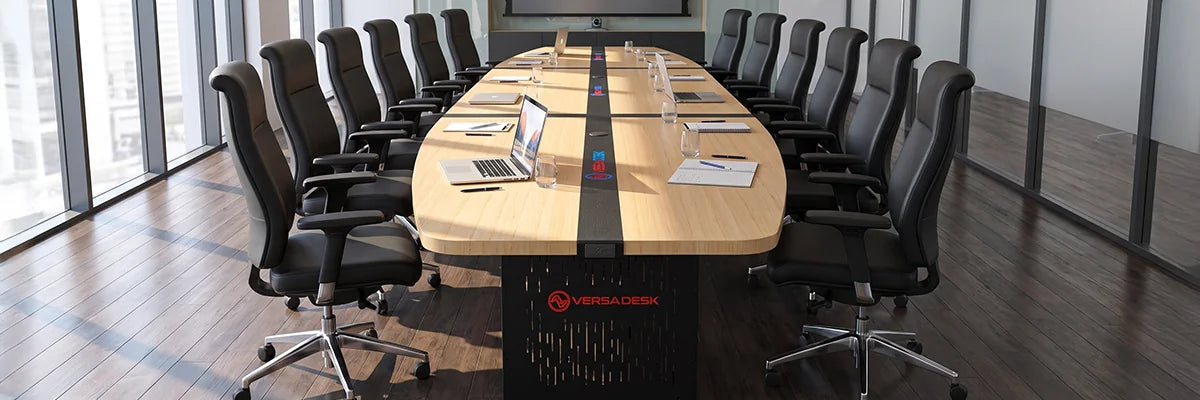 Large oval bamboo VersaDesk conference table with black leather high-back chairs in executive boardroom with floor-to-ceiling city views