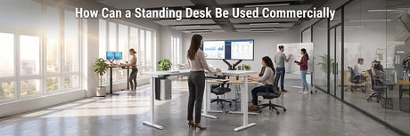Open-plan commercial office with employees using VersaDesk standing desks alongside seated workstations and a whiteboard meeting area
