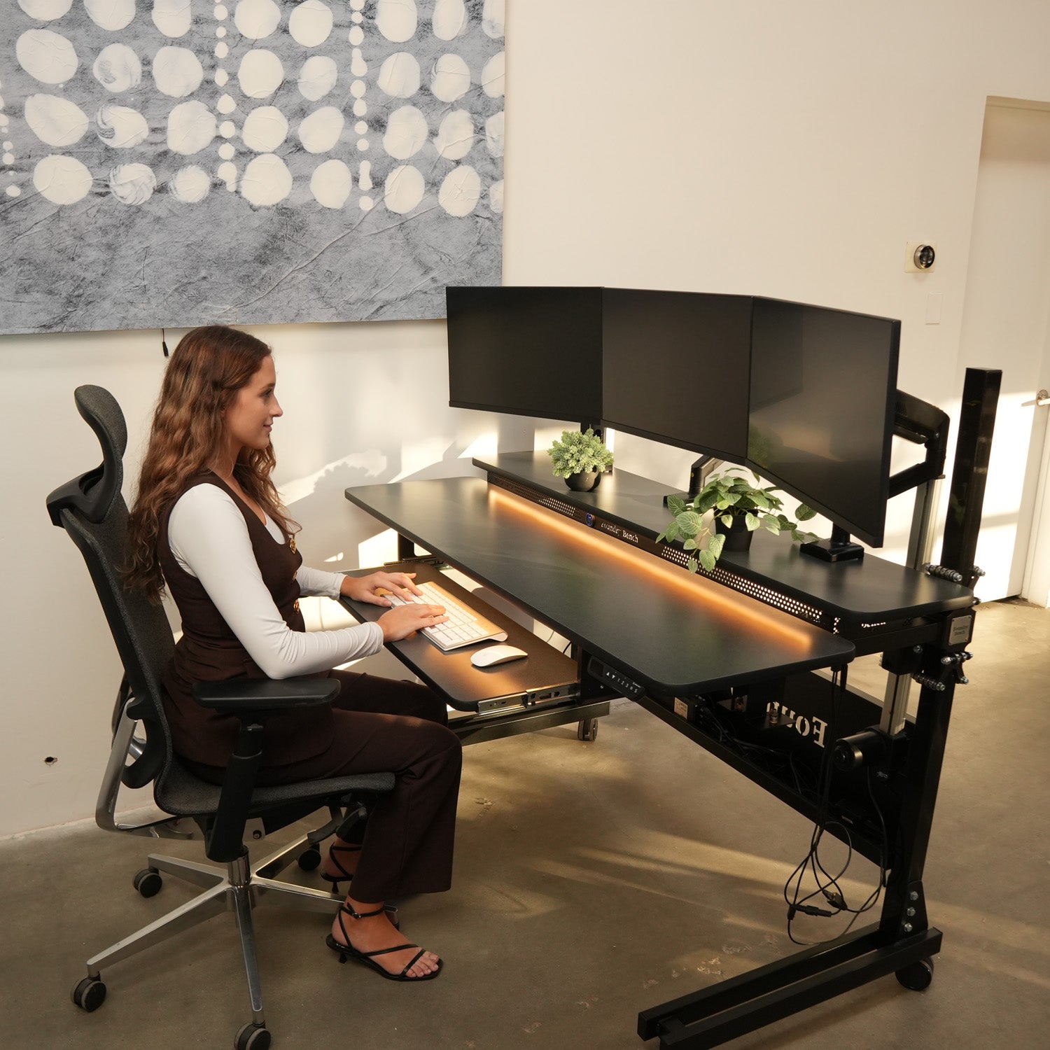 Sit stand desk with ergonomic office layout and organized workspace setup
