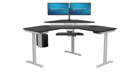 Large corner sit-stand desk with triple screen office setup