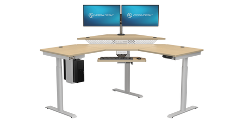 Ergonomic standing desk with three monitors for a multitasking workflow