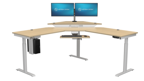 PowerLift sit stand desk for gaming setup with multiple displays